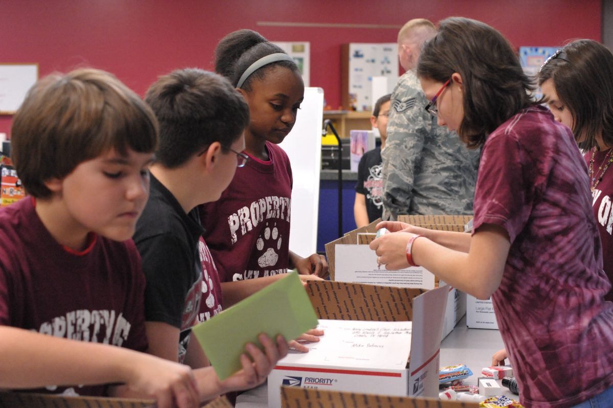 Kids making packages for the troops for Operation Shoebox (Credit: Joint Base San Antonio, Airman 1st Class Alexis Siekert)