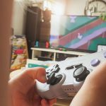 A young child playing colorful videogames on the living room television. (Photo by Sigmund on Unsplash)